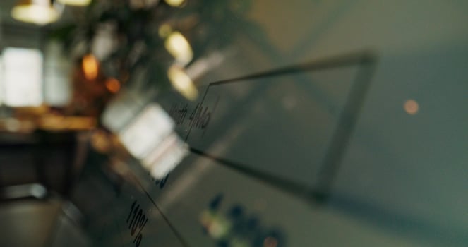 A close up of a glass wall with a computer screen photo