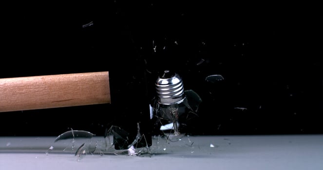 A hammer is being smashed by a glass photo