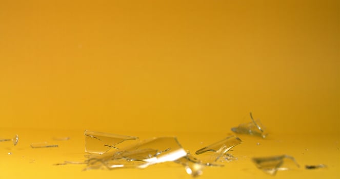 Broken glass on yellow background photo