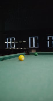 A pool table with a green cloth and a yellow ball photo