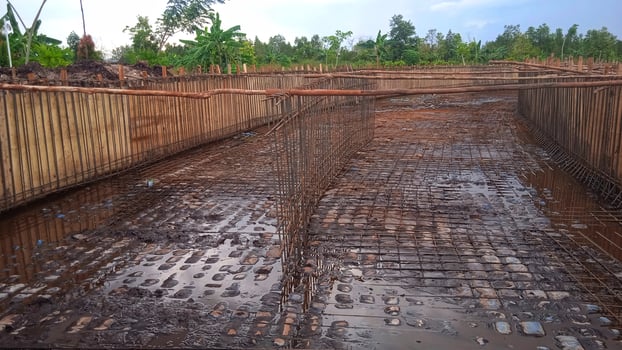 A large concrete pit with a fence around it photo