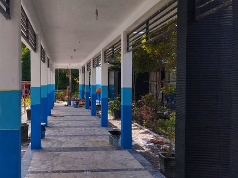 Long corridor, connecting road between buildings with white and blue pillars on the right and left, photo
