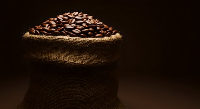 Jute bag filled with coffee beans photo