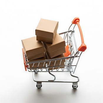 A miniature shopping cart filled with stacked cardboard boxes on a white background in a studio shot photo