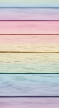 A pastel colored wooden surface with horizontal planks and a soft gradient effect on the wood photo