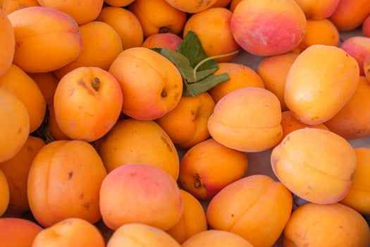 A Crate of Sweet Apricots at a Local Market Stall. Concept The taste of locally grown fruit. photo