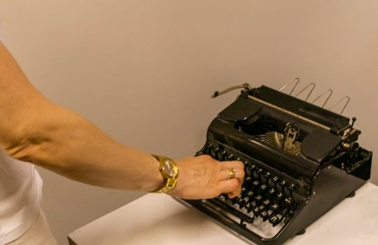 Woman typing on the old, vintage, russian typewriter. photo