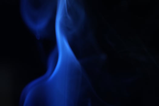 Blue smoke on black photo