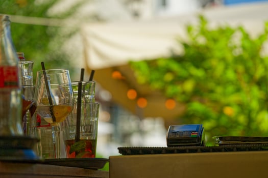 street restaurant in the summer with glasses, bottles and a EC Cash Visa Mastercard payment terminal photo