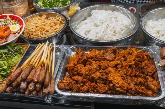 traditional Vietnamese food and meat on counter at Asian night market on street in Da Nang in Vietnam in Asia photo