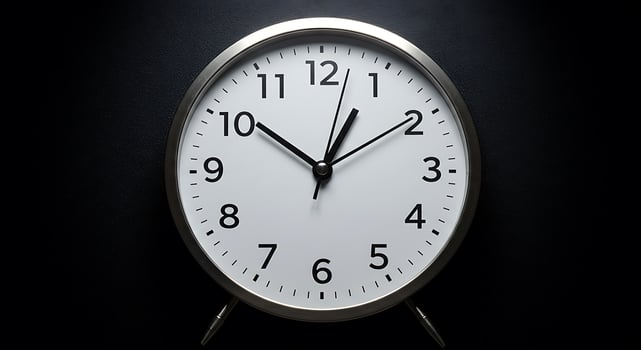 A clock is shown on a black background photo