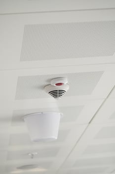 Ceiling smoke detector in modern building photo