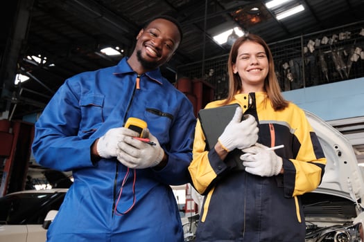 Happiness professional teamwork, White female inspector engineer and Black mechanic man cheerful, arms crossed with smile in fix car garage, maintenance jobs in automotive transportation industry. photo
