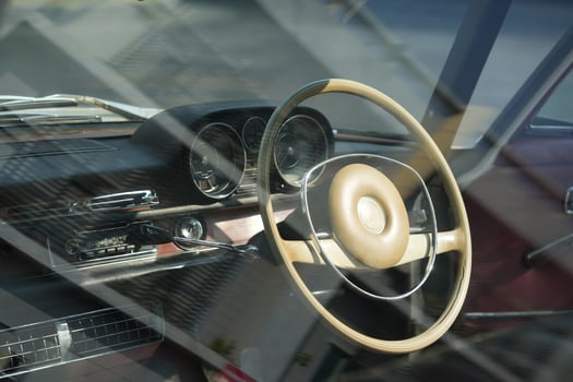 Vintage Classic car steering wheel, with chrome and leather textures in sharp detail, showcases the quality and precision of automotive craftsmanship under natural light.ba photo