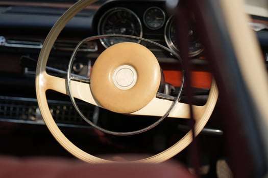 Vintage Classic car steering wheel, with chrome and leather textures in sharp detail, showcases the quality and precision of automotive craftsmanship under natural light.dxb photo