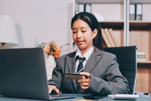 Asian business woman using credit card and laptop photo