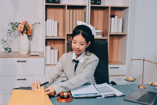 A woman in a suit is working at her desk photo