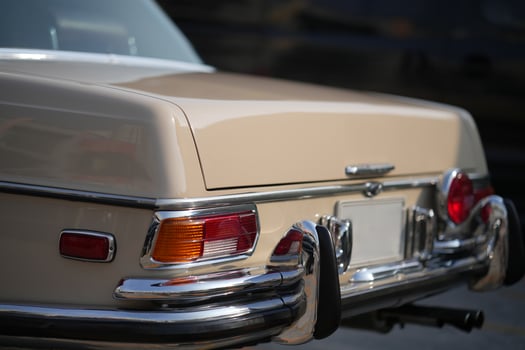 The tail lights, turn signals, and chrome accents on the rear of classic cars exude vintage charm and sophisticated design.c photo