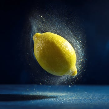 A bright lemon suspended in a glittering, magical swirl of light. photo