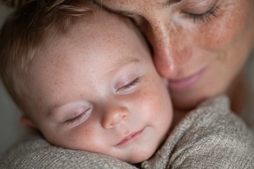 A woman is holding a baby and smiling photo