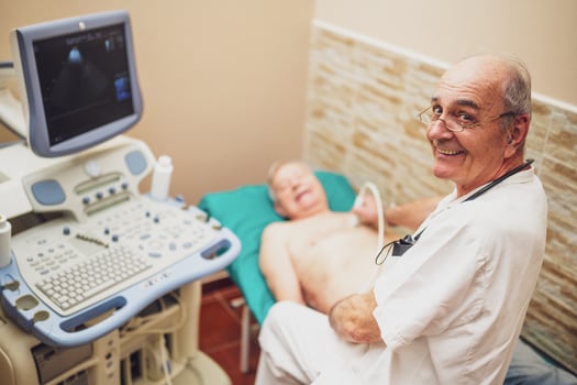 Cardiologist performing an echocardiogram on a senior patient, using ultrasound equipment to diagnose chest pain and hypertension. photo