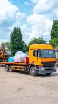 A large truck with a trailer on a dirt road photo