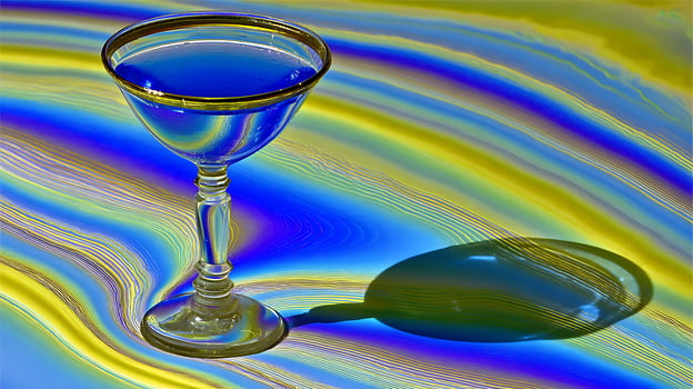 Crystal Clear Martini Glass Reflects Psychedelic Waves of Color. photo