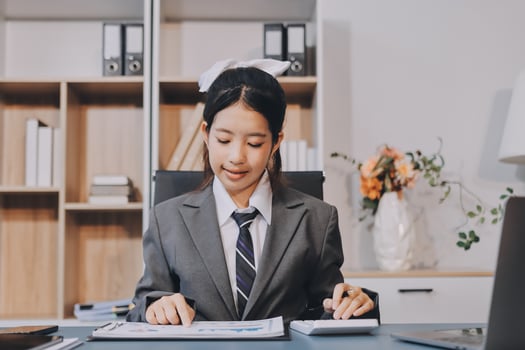 Asian business woman in office working on paperwork photo