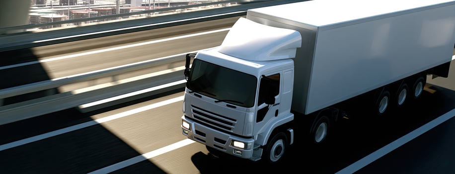 A white truck driving on a highway photo