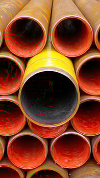 A bunch of pipes stacked together photo