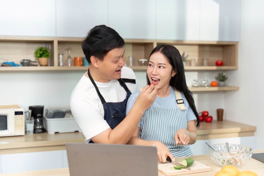 Healthy Cooking Together. Couple Sharing Ingredients in Bright Kitchen photo