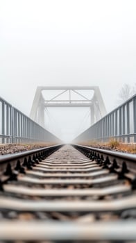 Ethereal railway bridge emerges from dense fog, a mysterious path into the unknown. A serene and atmospheric journey along the tracks, disappearing into the misty horizon. photo