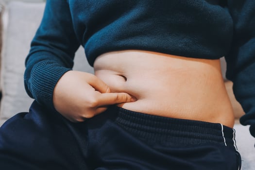 A person is holding their stomach with their hand photo