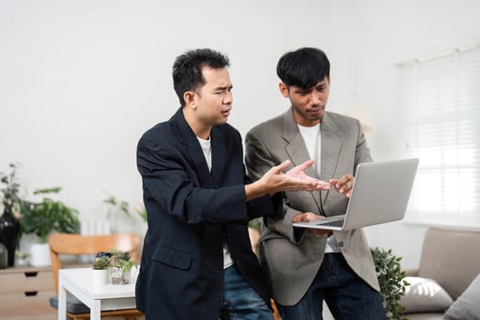 Business Discussion and Collaboration. Two professionals engaging in a serious conversation about project challenges in a modern workspace. photo