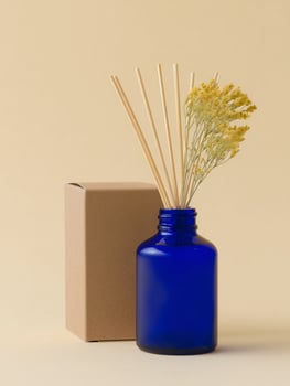 Blue Bottle with Reeds and Dried Flowers Near Box photo