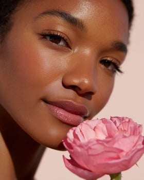 Woman's Face and Pink Rose Close-up photo