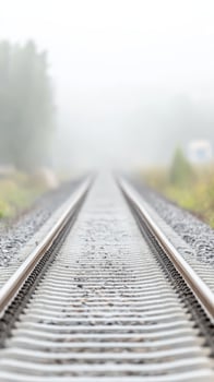 Enigmatic Railway Tracks Disappearing into Dense Fog, Evoking a Sense of Mysterious Journey and Vanishing Horizons in a Serene Landscape photo