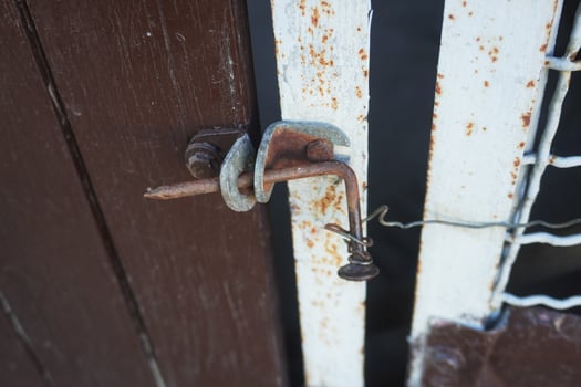 An old nail and wire lock. At first glance, it looks flimsy, but it's a time-tested thing that allows you to protect yourself from unauthorized entry. photo