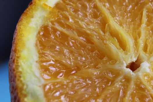 cut orange close-up. Macro photo of eating orange fruit. Orange fruit background
