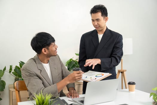 Business Collaboration and Meeting. Two professionals engaged in a discussion about project strategies in a modern office setting. photo