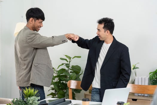 Business Collaboration and Fist Bump. Two professionals celebrating a successful meeting with a fist bump in a modern office. photo