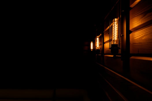 Incandescent bulbs with filament burning in the dark photo