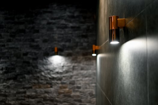 Modern lighting in an interior with a stone wall photo
