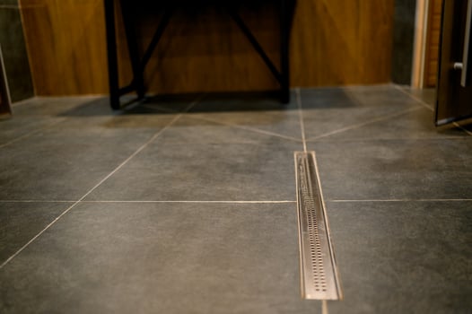 Bathroom floor with drainage grate photo