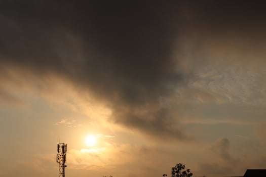 Sun shining through scattered clouds in a sky transitioning photo