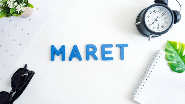 Flat lay composition with blue color foam letters spelling word MARET isolated on white background photo