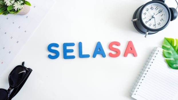 Flat lay composition with red and blue color foam letters spelling word tuesday in Indonesian, SELASA isolated on white background photo