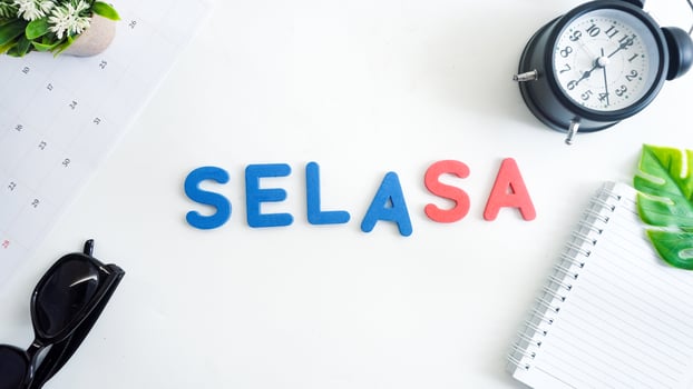 Flat lay composition with blue and red color foam letters spelling word tuesday in Indonesian, SENIN isolated on white background photo