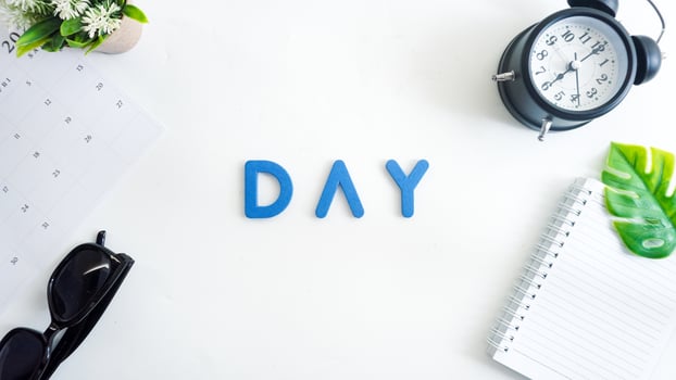 Flat lay composition with blue color foam letters spelling word DAY isolated on white background photo