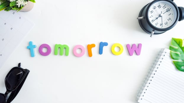 Flat lay composition with colorful foam letters spelling word TOMORROW isolated on white background photo